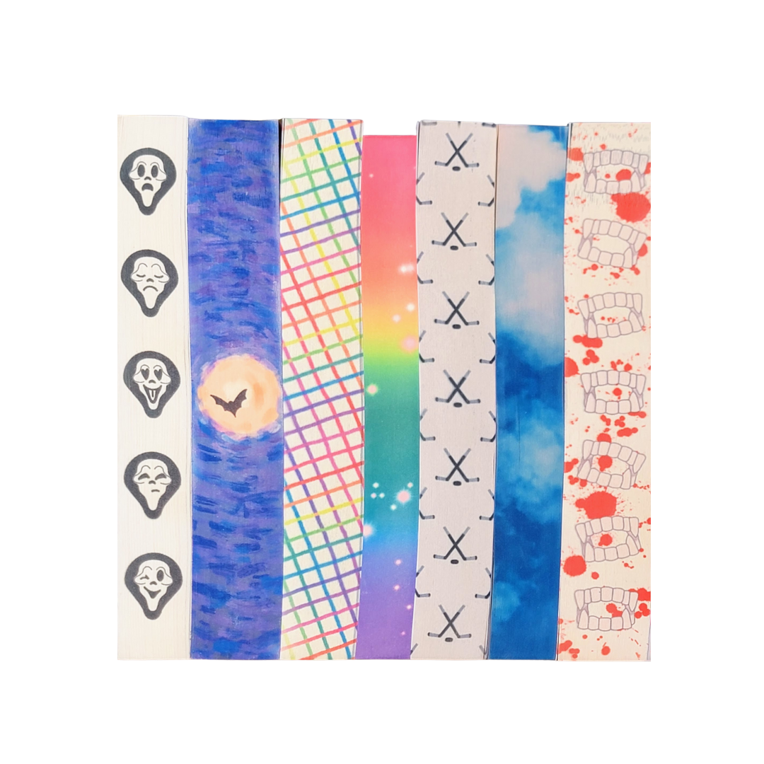 set of seven paperback books with charmed ink edge designs on the page edges